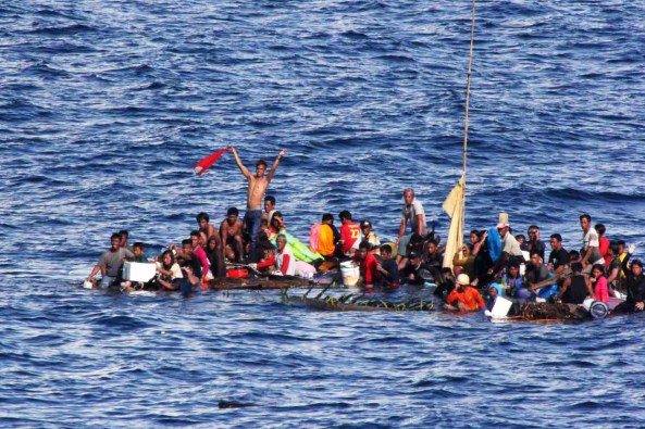 150610-M-ST621-140 MAKASSAR STRAIT (June 10, 2015) Distressed persons wait to be rescued by Sailors and Marines aboard the amphibious dock landing ship USS Rushmore (LSD 47) in the Pacific Ocean. Rushmore rescued 65 people after it was discovered they were floating on bamboo rafts tied together and with no means of propulsion. Once on board, the rescued individuals were provided food and medical attention by Marines and Sailors from the 15th Marine Expeditionary Unit and the Essex Amphibious Ready Group. (U.S. Marine Corps photo by Sgt. Emmanuel Ramos/Released)